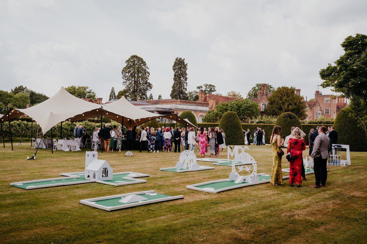 PutterFingers silver mini golf course set up on the lawn for a wedding drinks reception